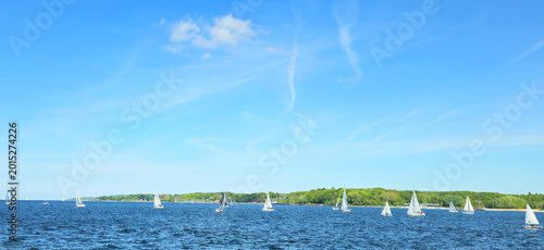 Quadro su tela Sailboats on Kiel Fjord sailing in strong wind with choppy open water and cloudy