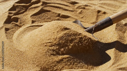 Close up of sand shovel with pile of sand for construction and industry