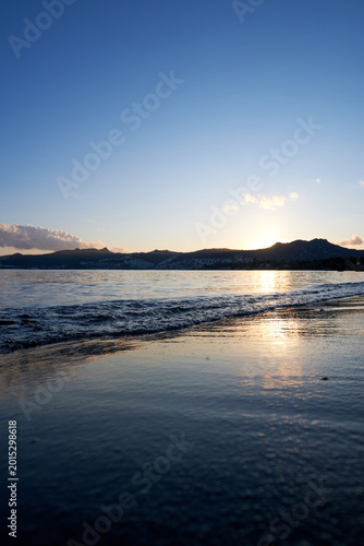 Beautiful sunset colors reflecting on the calm ocean water surface