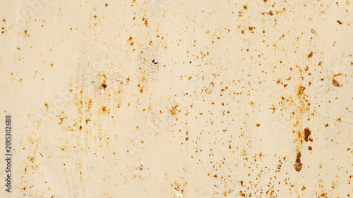 Textured surface of weathered metal sheet with rust spots and stains, showcasing a distressed appearance suitable for backgrounds or design elements