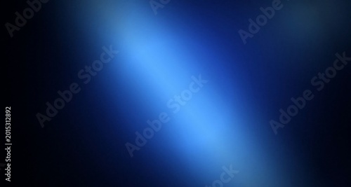 Photos A gradient blue light beam shining brightly on a dark background with vibrant co