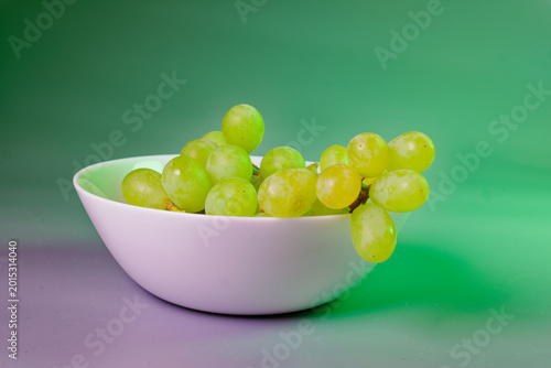 Grape fruit on bowl still life on green background