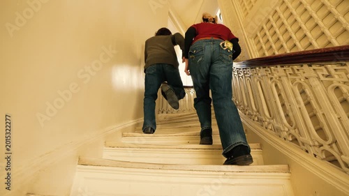 Young People Walking Up Spiral Stairs