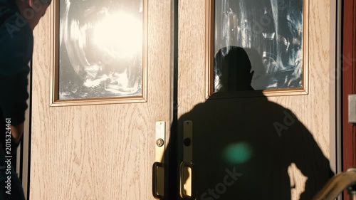 Young Men Walking Through Door of Building