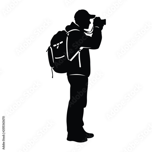Silhouette of a photographer with backpack and camera
