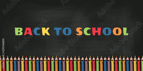 Fotografie Back to school background featuring colorful chalk style lettering on a blackboard with a row of bright pencils