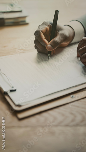 The businessman is reviewing the documents