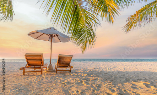 Fotografie Wide panoramic view of beautiful tropical sunset scenery with two sun beds and u