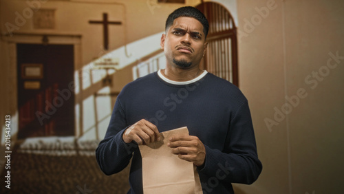 Canvastavla Man with beard holding and tearing a paper bag in a church nave with wooden pews, arched doorway and wall cross visible; suspicion doubt