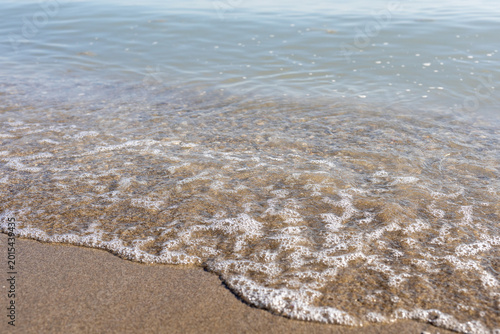Foto Sparkling sea waves under bright midday sun