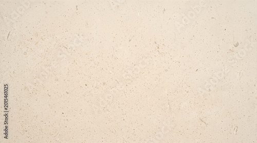 Pale beige natural stone surface with speckled granular texture