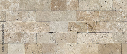 Seamless brickwork texture of natural beige travertine with characteristic pores and surface irregularities. Seamless stone cladding pattern in Mediterranean style for architectural visualization.