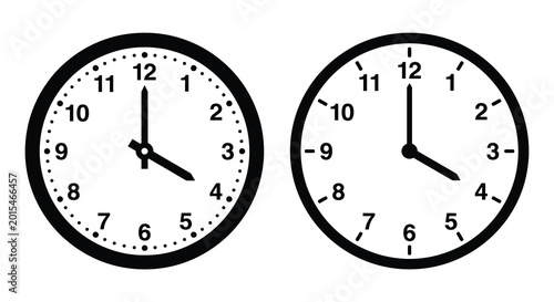 Photography Two black clock face silhouettes showing different times isolated on white backg