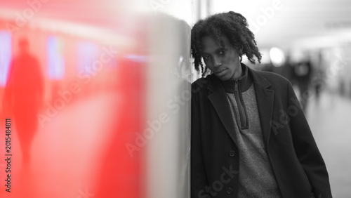 Moody African Man in Black and White with Red Blurred Foreground and Copy Space
