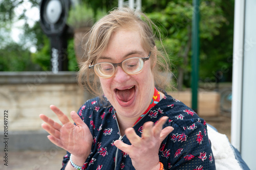 Fotografia Excited woman with Down syndrome celebrating outdoors