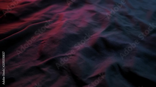 Slow Ripples of Dim Color Gliding Across a Wrinkled Dark Fabric Surface: Cinematic Abstract Motion Loop (16:9)