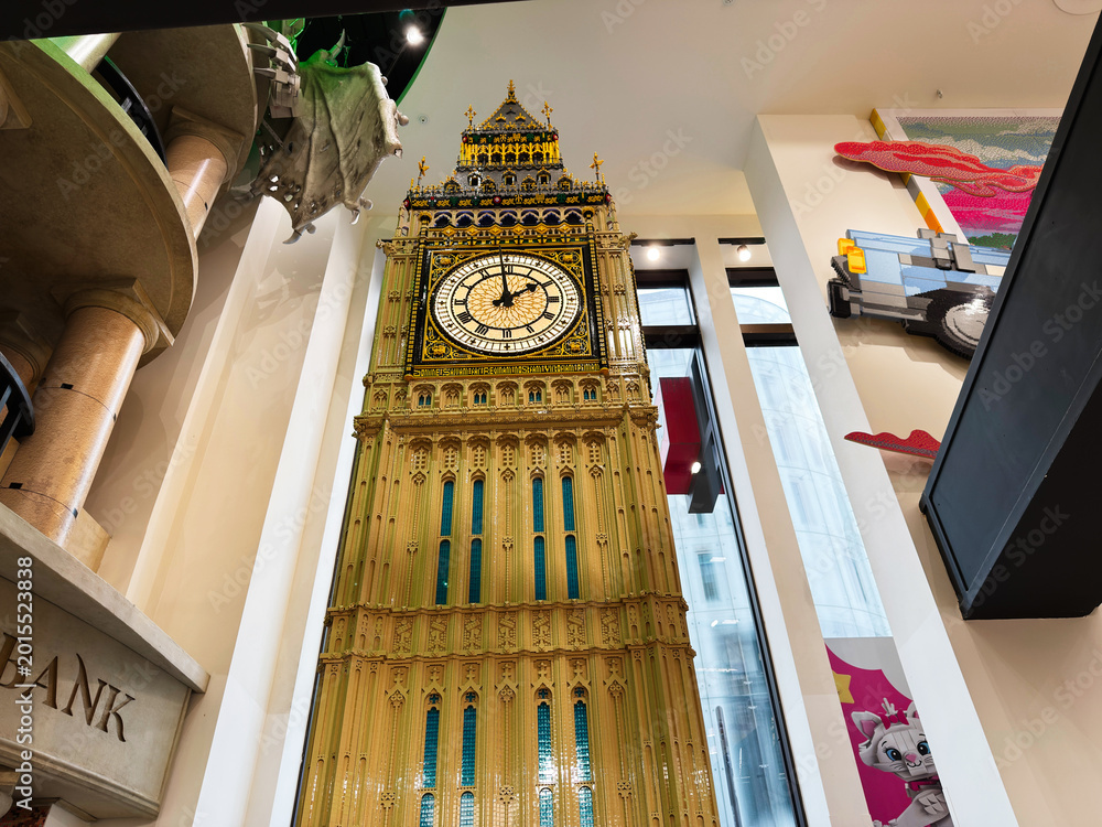 Obraz premium Detailed Big Ben clock tower replica display inside a LEGO store in London, UK with ornate golden architecture and towering interior perspective