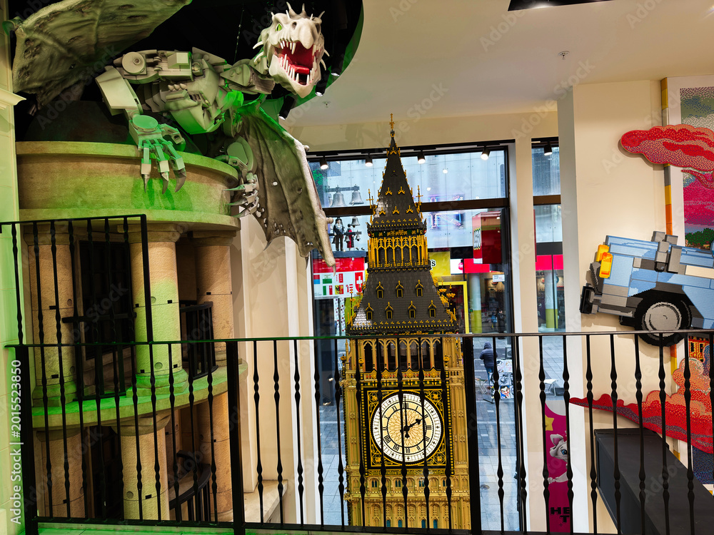 Naklejka premium LEGO Big Ben model and dragon display inside a colourful toy store in London, UK with clock tower replica and playful street view