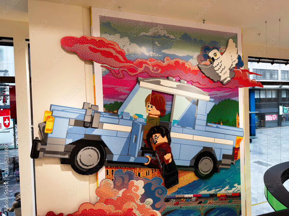 Obraz premium Colorful LEGO mosaic of a flying car with wizard toy characters and owl installation in a London, UK store window