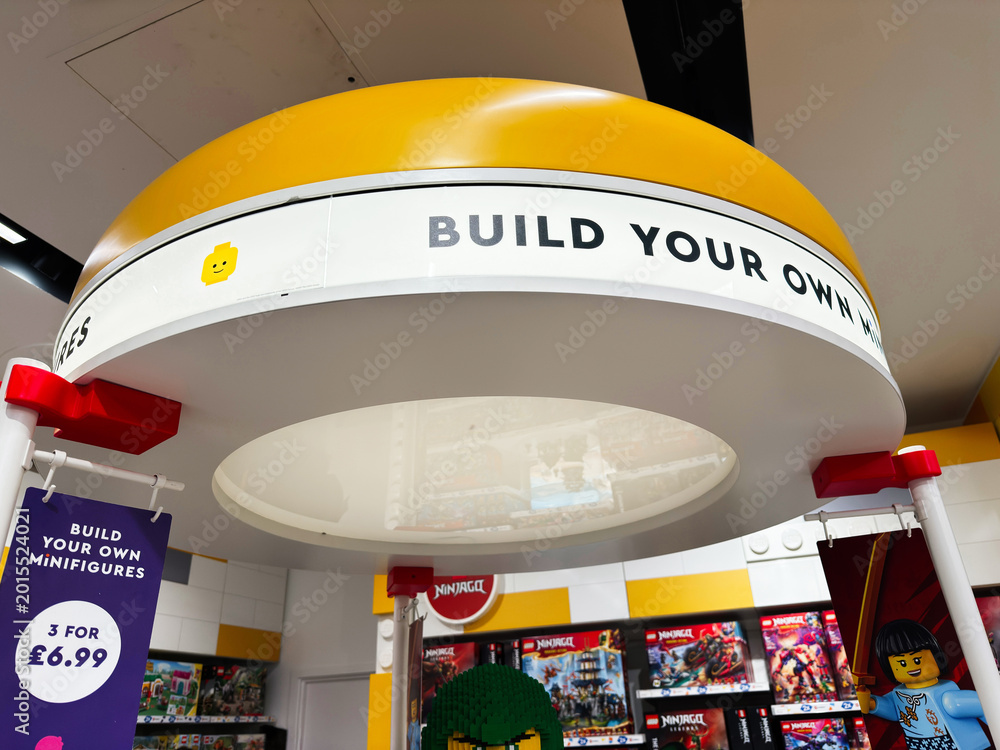 Fototapeta premium Build your own minifigures display at a LEGO store in London, UK with colorful bricks, signage and retail canopy showcasing toys, shopping and creative play in a modern family friendly interior