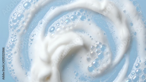 Creamy white swirl with bubbles on light blue background for skincare cosmetics dairy products and fresh clean design concepts.