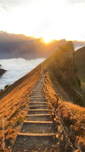 Sunset on the ridge hike from Stoos with a stepped path in the foreground and a breathtaking sea of fog in beautiful autumn time