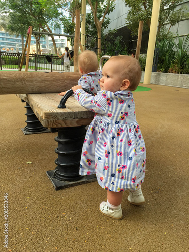 small twin girls on the playground