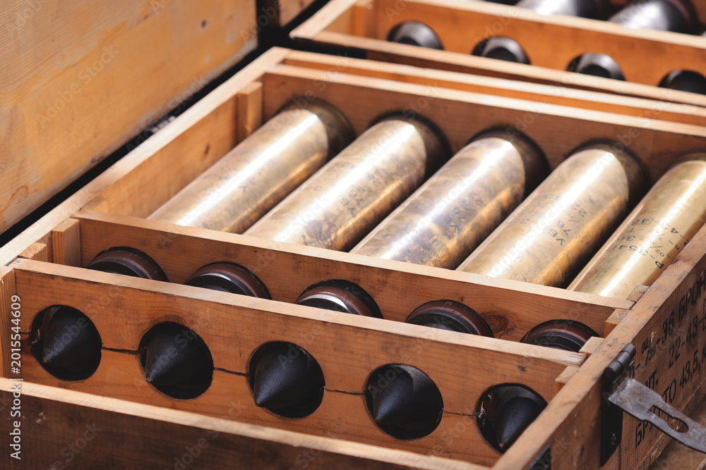 Naklejka premium A wooden box filled with numerous wine bottles