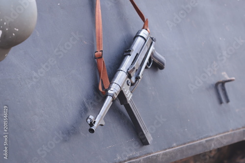 Fotografie A firearm hangs on the side of a wall in a compact and tidy manner, ready for us