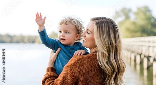 A tender moment between mother and child by the water's edge, highlighting the importance of nurturing connections with nature and fostering environmental stewardship.