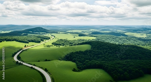 An expansive aerial view of rolling green fields and dense forests, illustrating the interconnectedness of ecosystems and the importance of preserving natural habitats.