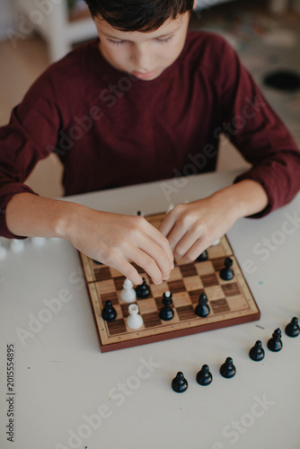 Boy is playing chess