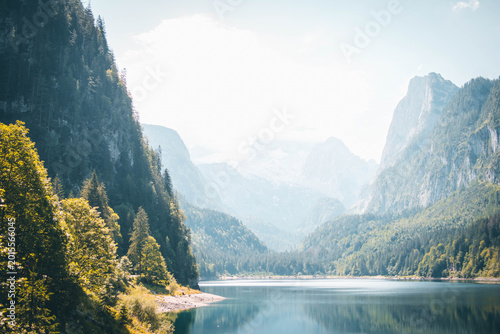 Tableau sur toile Idyllic landscape of a peaceful alpine lake surrounded by forests