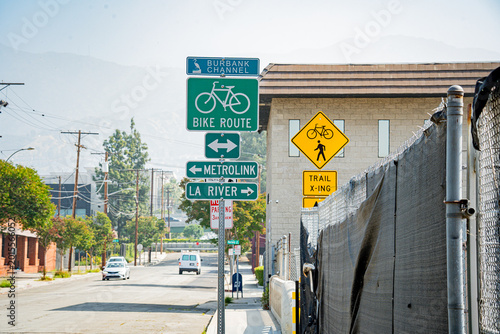 Fotografie Street signs indicate bike route, Metrolink, and La River trail crossings