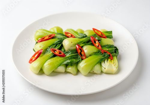 Fresh stir-fried greens with red chili peppers on a plate