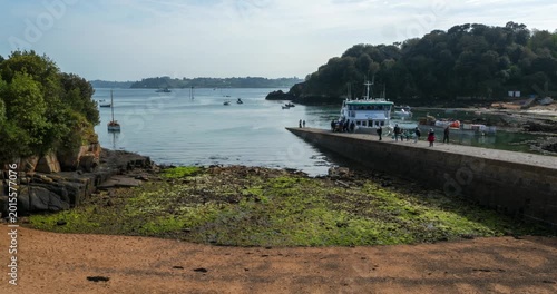 Timelapse showing port and marina activity on Brehat Island in Brittany, France. Tourist movement, boats and coastal atmosphere of the French shoreline during sunny day.