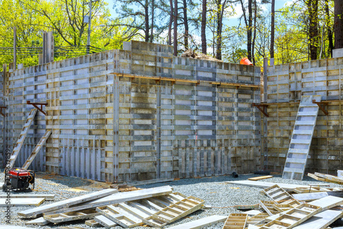 Construction site progress on new building structure in forested area