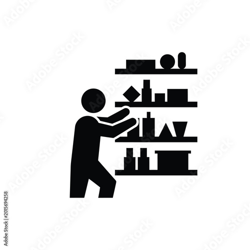 Man holding object on shelf unit.