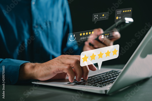 Smartphone customer review rating online feedback system experience evaluation digital marketing service improvement brand reputation icons appear, as man types on laptop computer
