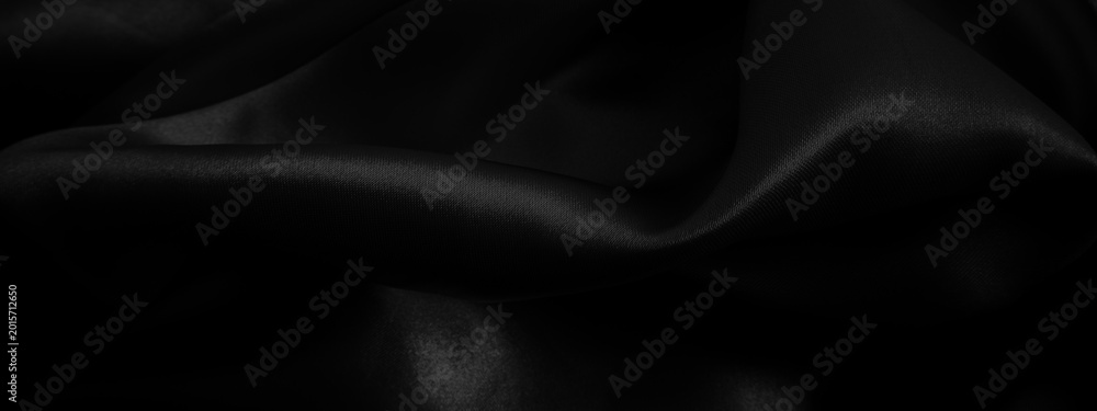 Fototapeta premium Black fabric background. Cloth wavy texture