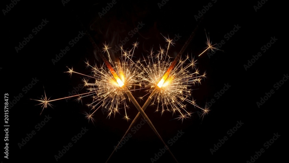 Fototapeta premium Two burning sparklers with bright sparks on dark background at night festive celebration