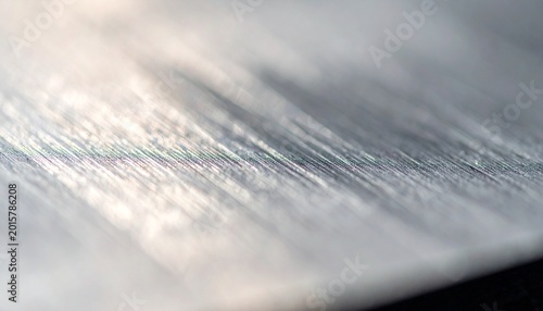 Macro close-up of metal surface texture representing industrial material, soft lighting highlighting detail. Clean abstract usable texture.