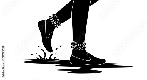 Silhouette of Indian legs with traditional anklets stepping into water puddle