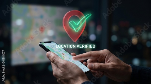 Mobile phone displaying a verified location pin with a checkmark, demonstrating digital verification and tracking services