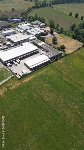 Industrial Landscape: An aerial perspective reveals an industrial complex nestled amidst verdant fields, a harmonious blend of manufacturing and natural surroundings.