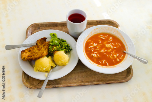 Polish food at the milk bar. Tomato soup with pasta and pork chop with potatoes and salad.