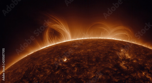 Large solar flares erupt from the surface of the sun during a sunny day in space as observed by a telescope