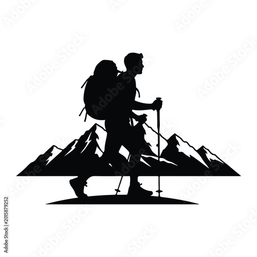 Hiker silhouette with backpack and trekking poles, against mountain range