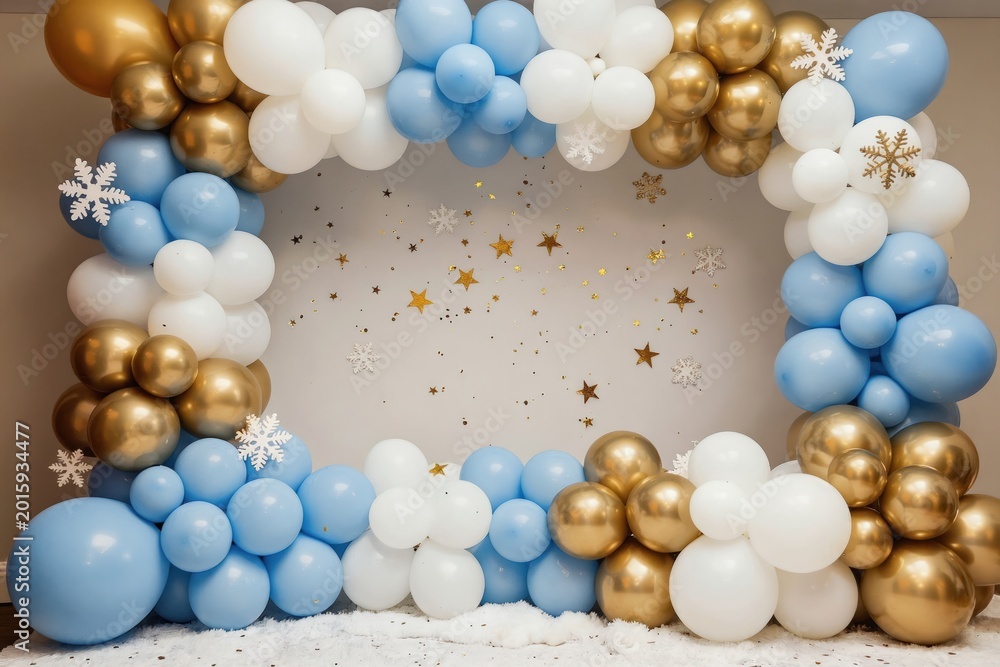 Fototapeta premium Archway decorated with blue white and gold balloons. Snowflakes and stars adorn festive party backdrop. Perfect for winter holidays or any celebration event.