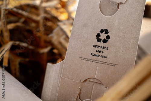 Close-up of recyclable cardboard packaging with reuse symbol, plastic-free concept. Sustainable materials and eco-friendly branding for environmental awareness.